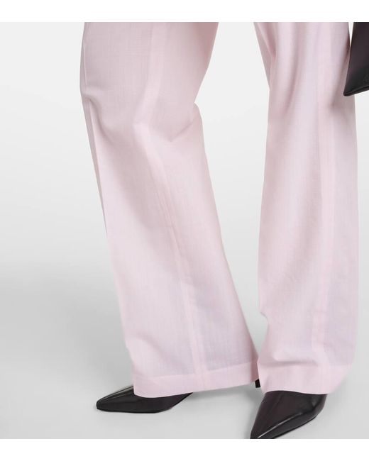 Pantaloni in lana a vita bassa di Coperni in Pink