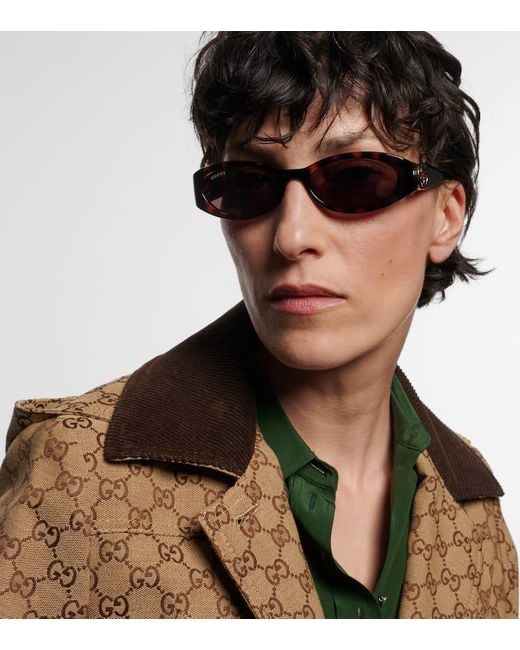 Occhiali da sole Interlocking G ovali di Gucci in Marrone Lyst