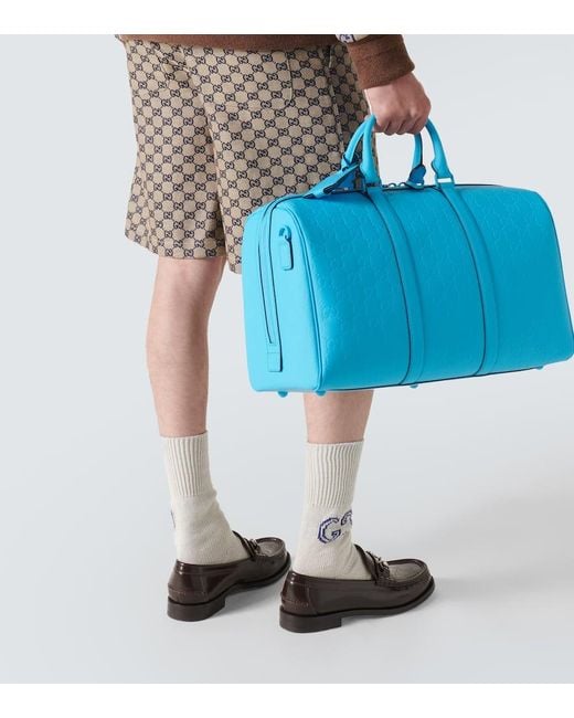 Bolso de viaje de PVC con GG grabada Gucci de hombre de color Blue