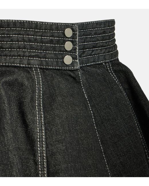 Minifalda de denim con peplum Alaïa de color Black