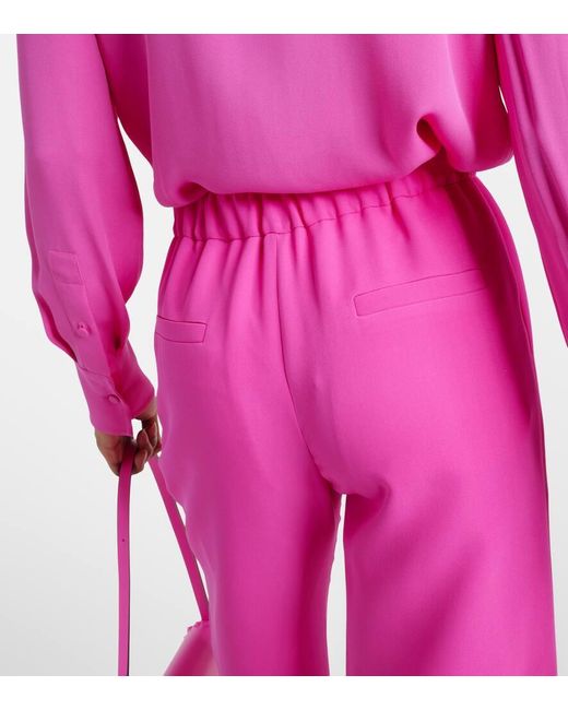 Pantalones palazzo de seda de tiro alto Valentino de color Pink