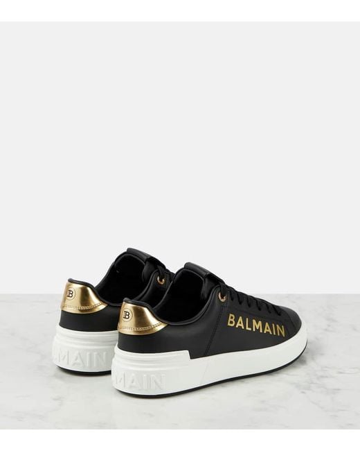 Sneakers in pelle di vitello nero/oro di Balmain in Black