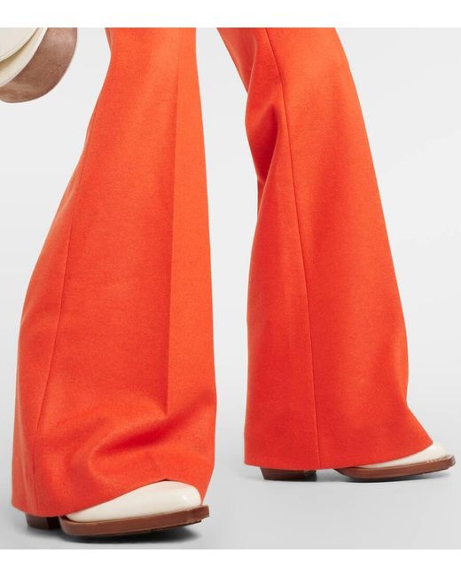 Pantaloni flared in jersey di lana di Chloé in Orange