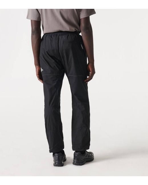 Pantaloni regular in tessuto tecnico di And Wander in Black da Uomo
