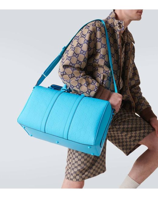 Gucci Blue GG Debossed Pvc Duffel Bag for men
