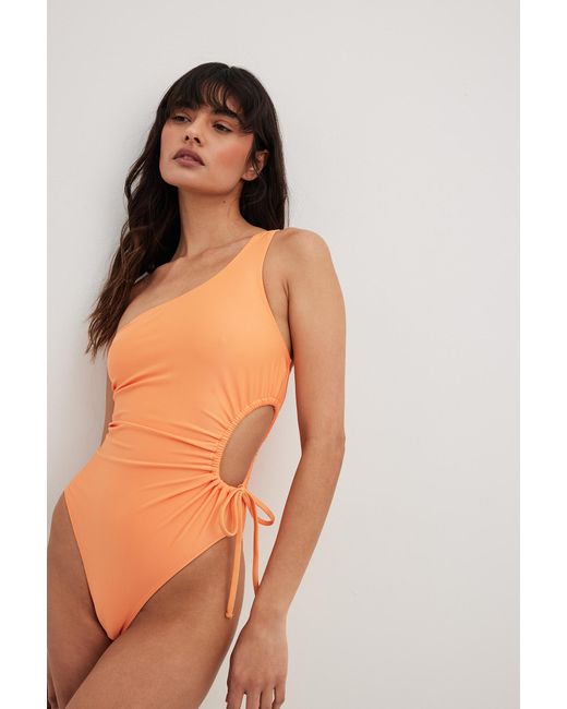 NA-KD Cut Out One Shoulder Swimsuit in Orange | Lyst