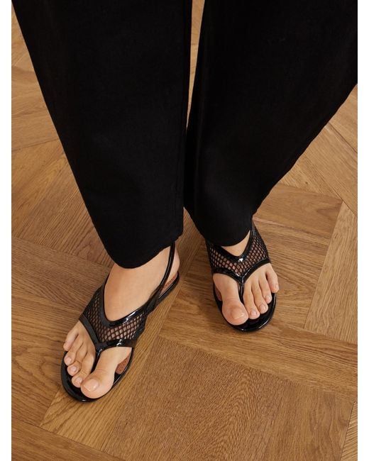 Alaïa Black Fishnet Flat Sandals