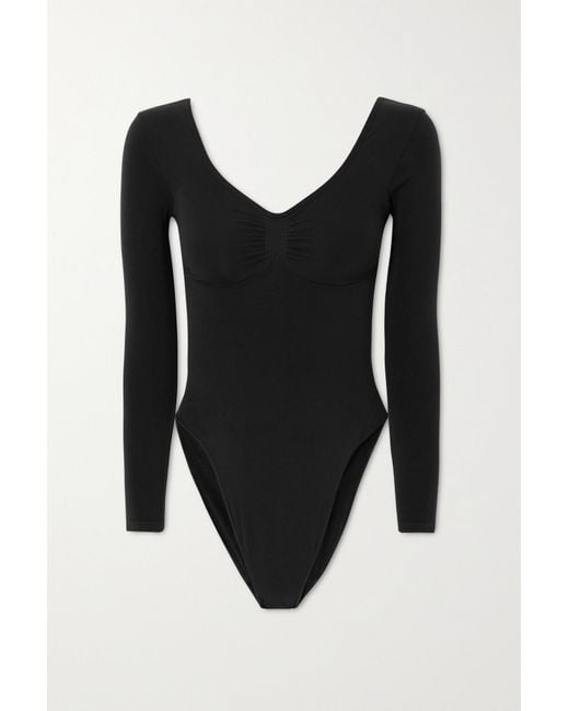 https://cdna.lystit.com/520/650/n/photos/net-a-porter/cc9b3420/skims-Black-Seamless-Sculpt-Long-Sleeve-Low-Back-Briefs-Bodysuit.jpeg