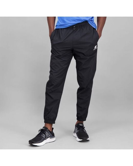 New Balance Nb Athletics Higher Learning Wind Trousers in Blue for Men ...