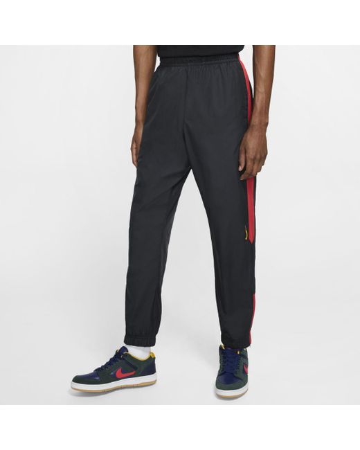 swoosh track pants