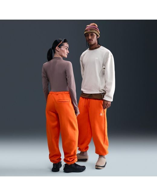 orange joggers nike