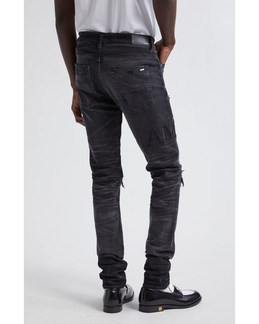 Amiri Black Bouclé Logo Ripped Mx1 Skinny Jeans for men