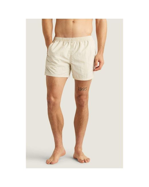AUTO-REPLY™ Natural Sebastian Solid 4-Inch Nylon Swim Trunks for men