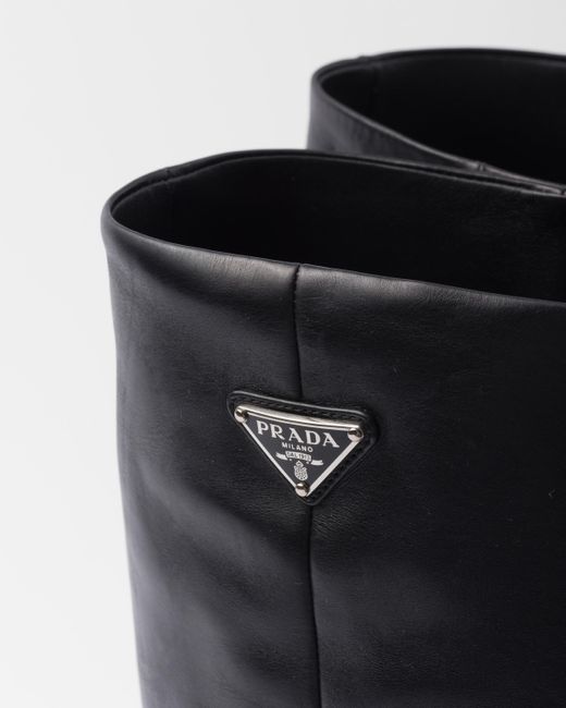 Stivali con placca logo di Prada in Black