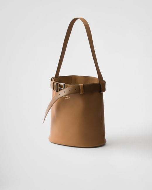 【日本入手困難】Prada Buckle leather bucket bag with belt Prada Buckle Leather Bucket Bag With Belt in White | Lyst