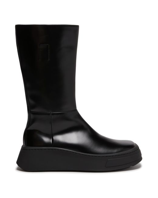 Bottes à semelles épaisses en cuir de veau Prada pour homme en coloris Black