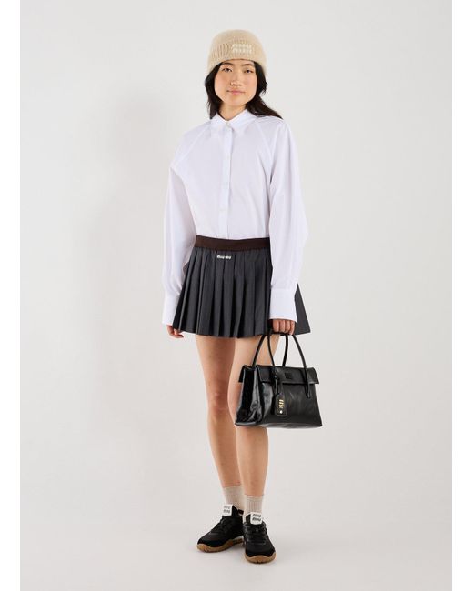 Jupe courte plissée Miu Miu en coloris Black