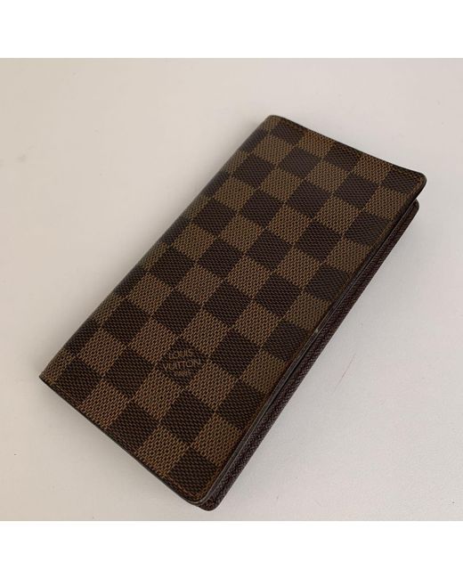 Louis Vuitton Damier Ebene Canvas Vertical Bifold Wallet in Brown for Men - Lyst