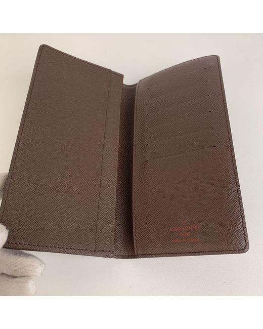 Louis Vuitton Damier Ebene Canvas Vertical Bifold Wallet in Brown for Men - Lyst