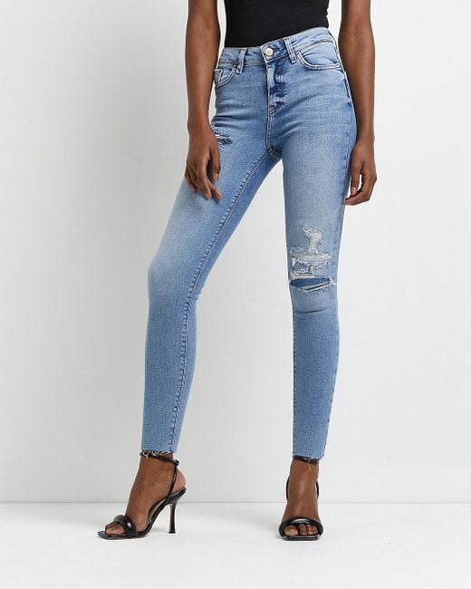 ripped mid rise skinny jeans