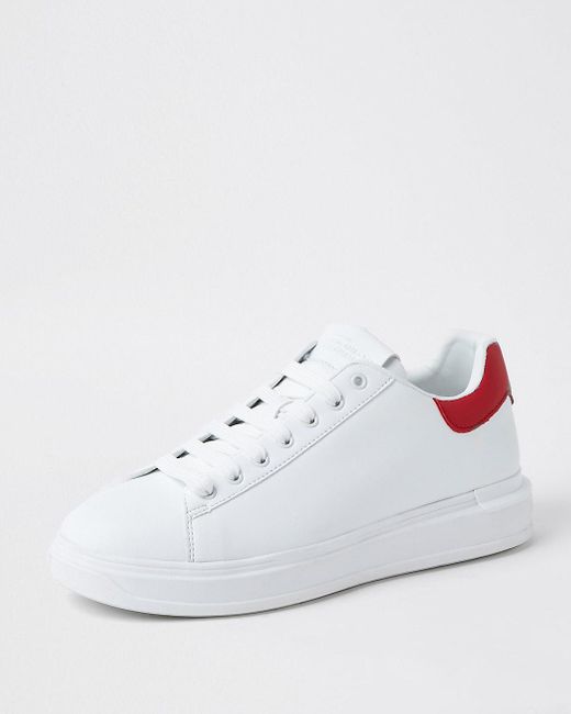white trainers with red back