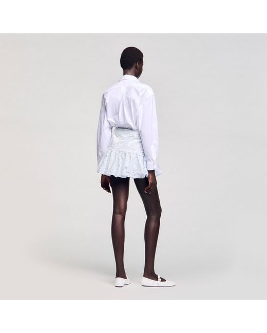 Jupe courte en guipure Sandro en coloris White