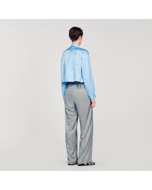 Pantalon en lin orné de strass Sandro en coloris Blue