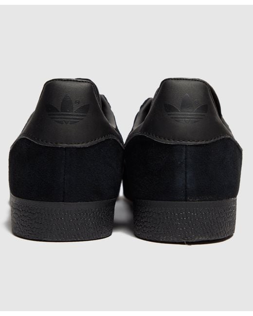 mens all black gazelles