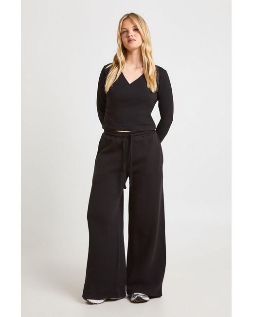 Boohoo Black Petite Wrap Front Long Sleeve Top And Straight Leg Jogger Tracksuit