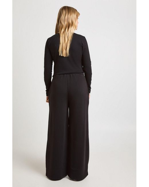 Boohoo Black Petite Wrap Front Long Sleeve Top And Straight Leg Jogger Tracksuit