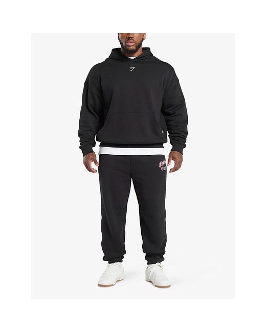 GYMSHARK Black Shark Text-Print Relaxed Cotton-Jersey Jogging Bottoms for men