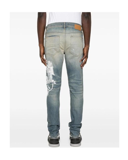 Amiri Blue Ripped Graphic Printed Jeans for men