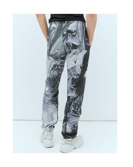 PRAYING Blue Garbage Graphic Track Pants for men
