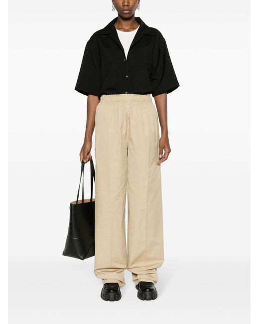 Prada Natural Triangle-Logo Plaque Wide-Leg Pants