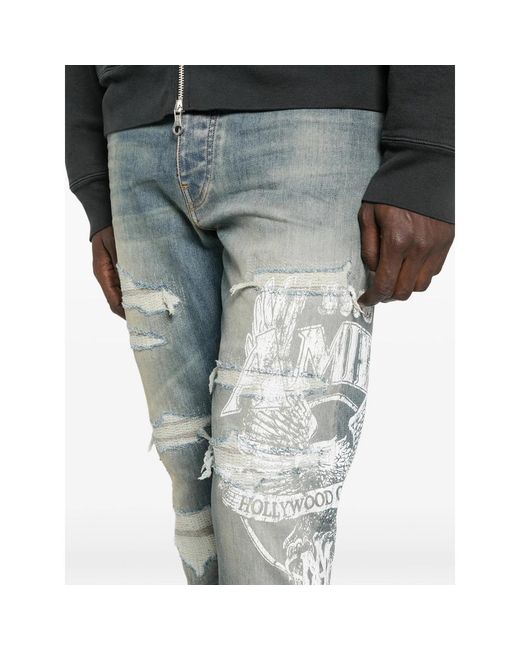 Amiri Blue Ripped Graphic Printed Jeans for men