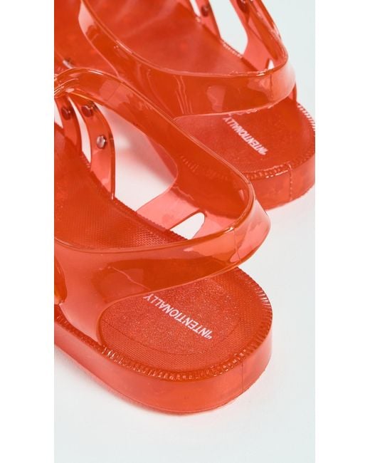 INTENTIONALLY ______ Red Ellery Studded Jelly Sandals