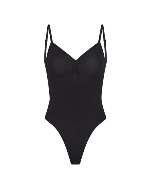 Skims Low Back Thong Bodysuit in Black Lyst