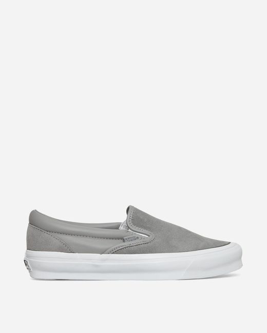 Vans white store slip on sneakers