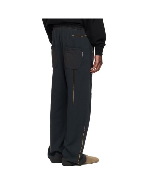 ANDERSSON BELL Black Piping Line Dyed Sweatpants for men