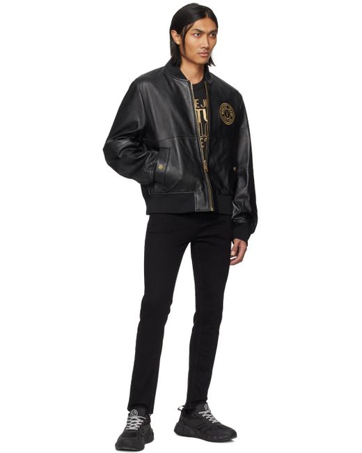 Jean noir à logo circulaire Versace pour homme en coloris Black