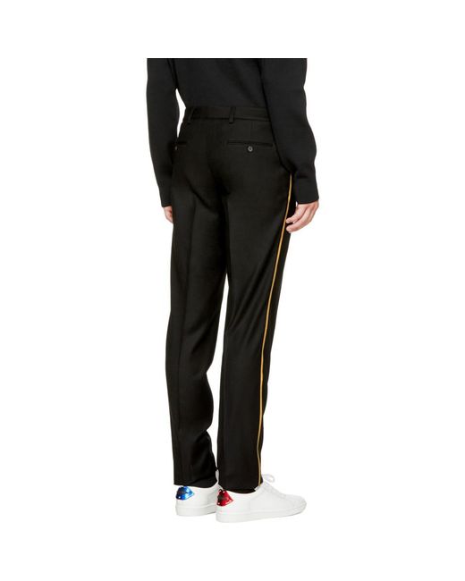 Black pants store with gold stripe