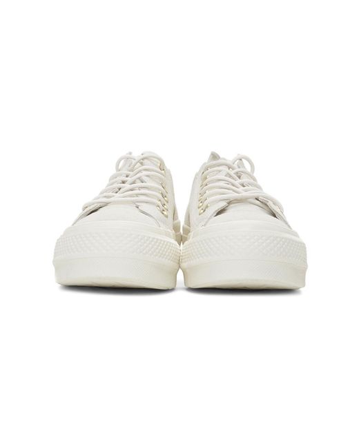 white frilly converse