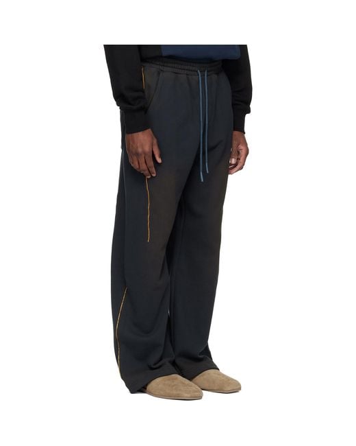 ANDERSSON BELL Black Piping Line Dyed Sweatpants for men