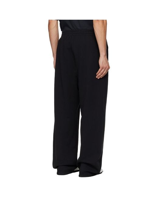 we11done Black Curved Sweatpants for men