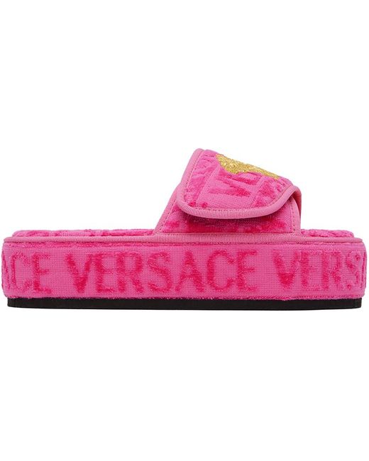 Pantoufles roses à motif à logo Versace en coloris Black