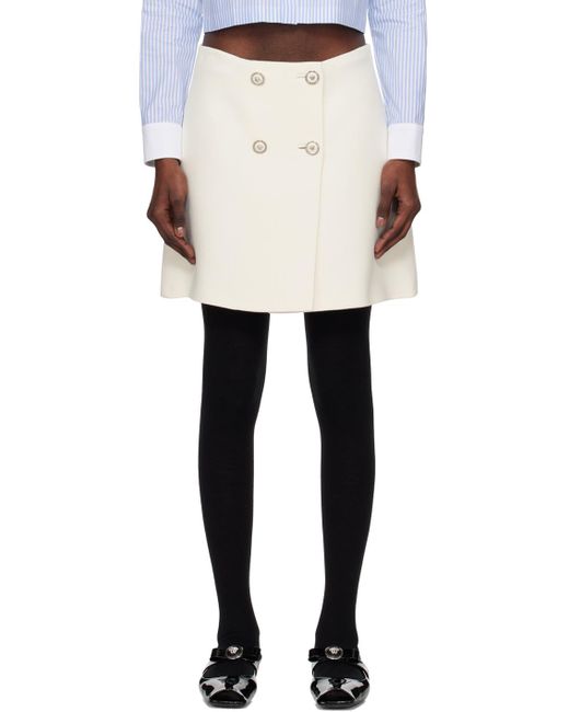 Mini-jupe portefeuille blanche Versace en coloris Black