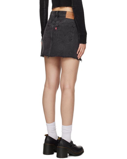 Mini-jupe noire en denim à bords bruts Levi's en coloris Black