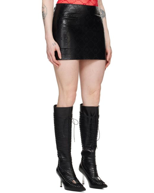 Mini-jupe noire en cuir à motif à logo gaufré MARINE SERRE en coloris Black
