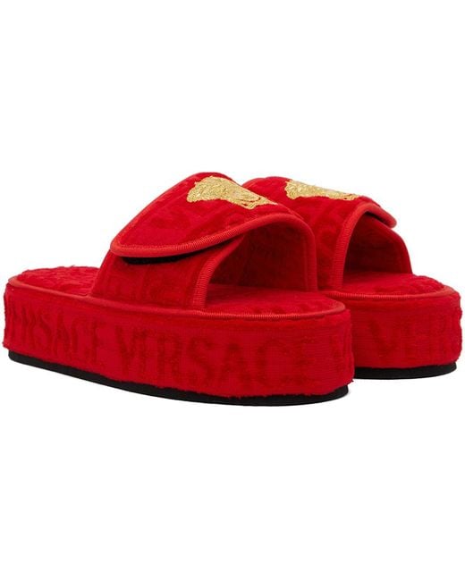 Pantoufles rouges à motif à logo Versace en coloris Red