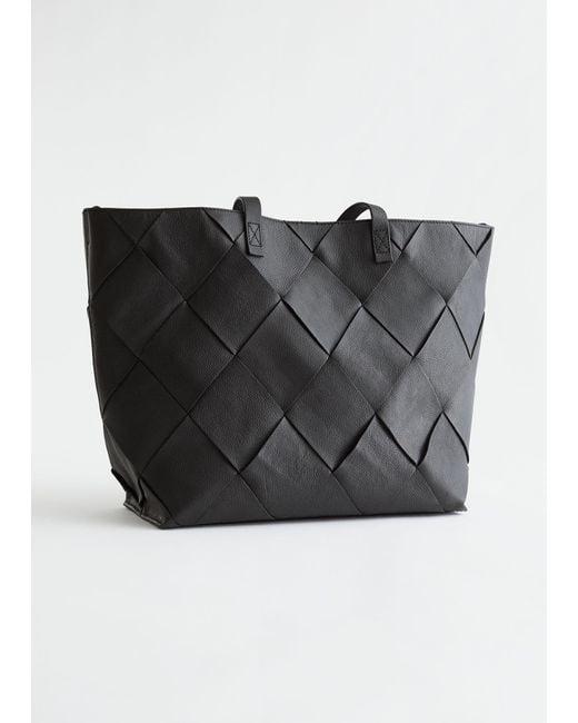 https://cdna.lystit.com/520/650/n/photos/stories/67e03a12/other-stories-designer-black-Tote-bag-en-cuir-tresse.jpeg